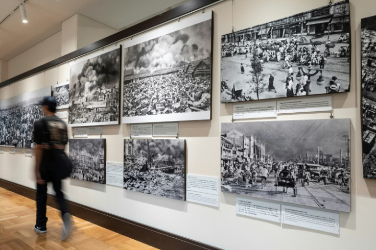 10万人以上の都民が亡くなった1923年の地震とそれに伴う火災の展示された映像の前を歩く訪問者